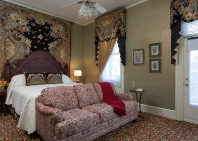 Lord Melbourne Guestroom Bedroom with Elegant Sofa at Foot of Bed and Stunning Tapestry and Matching Window Treatments